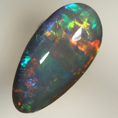 SOLID BLACK OPAL Bright rolling flashes over a medium high dome
